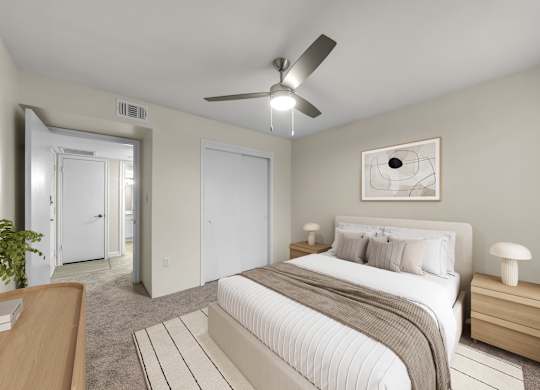 A bedroom with a large bed and a ceiling fan.