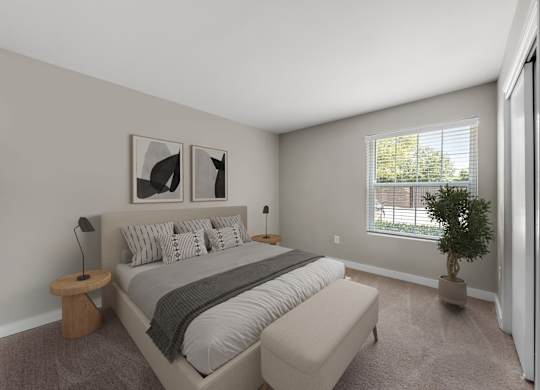 A bedroom with a large bed and two pictures on the wall.