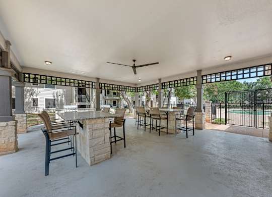 A patio with a bar and chairs is shown.