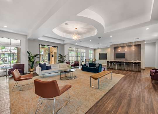 A living room with a white ceiling and wooden floors.
