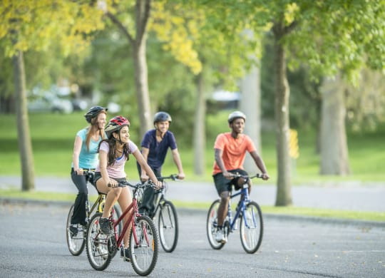 a group of people riding bikes down a street