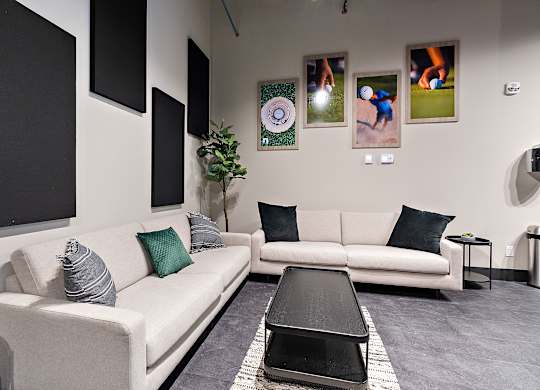 A living room with a white couch, a black coffee table, and a grey rug.at Raymond Block, Alberta