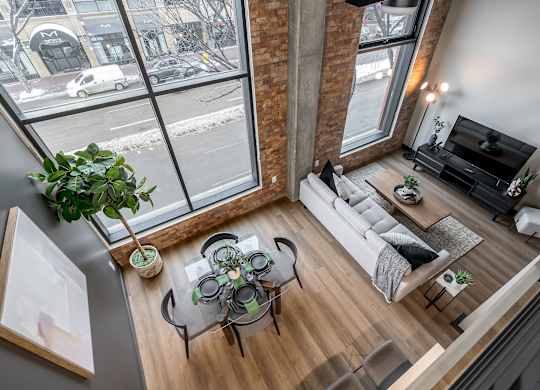 A living room with a glass table and a white couch.at Raymond Block, Edmonton, AB T6E 3R7