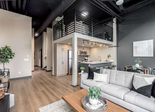 A modern living room with a grey sofa and a wooden coffee table.at Raymond Block, Edmonton, AB