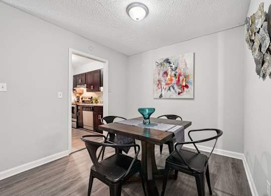 A dining room with a table and chairs.