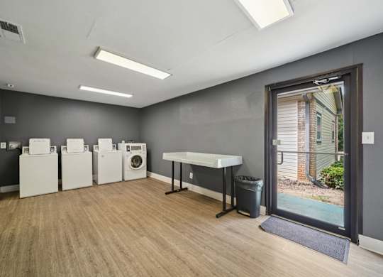 A laundry room with a washer and dryer set up next to each other.