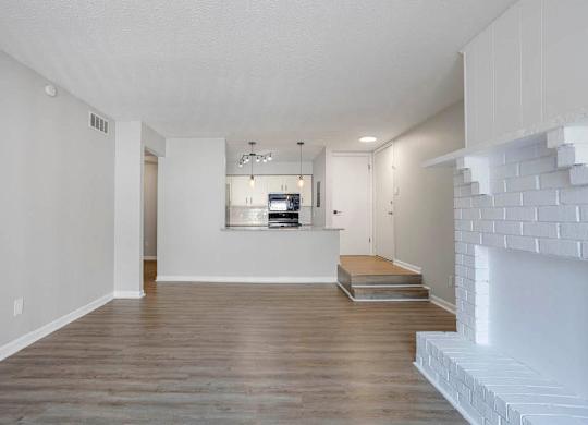 A modern living room with a fireplace and a flat screen TV at The Onyx Hoover Apartments, Hoover, Alabama