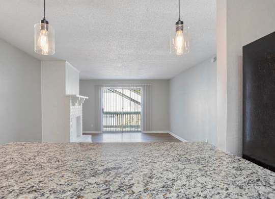 A bedroom with a large bed and a window with blinds at The Onyx Hoover Apartments, Alabama