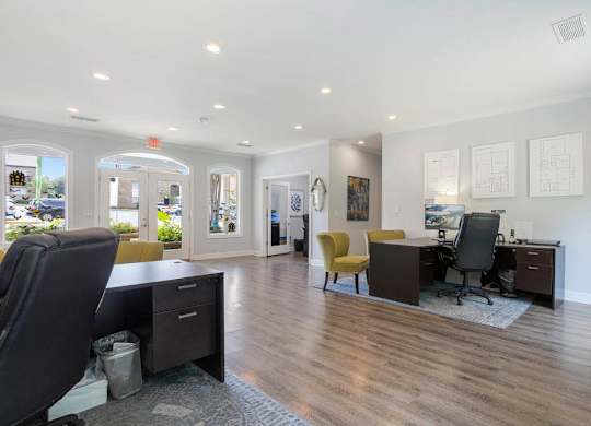 A spacious office with wood floors and white walls at The Onyx Hoover Apartments, Hoover, AL