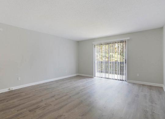 A room with wooden flooring and a window with blinds at The Onyx Hoover Apartments, Hoover