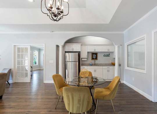 A dining room with a glass table and chairs at The Onyx Hoover Apartments, Alabama