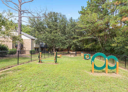 A playground with a green and yellow swing set at The Onyx Hoover Apartments, Hoover, AL, 35216