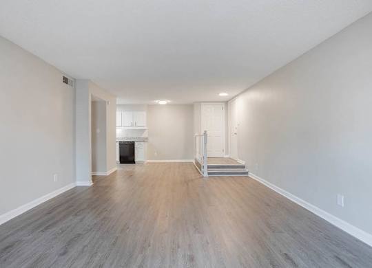 A spacious room with wood flooring and a fireplace at The Onyx Hoover Apartments, Hoover, AL, 35216