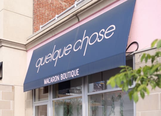 a storefront with a blue awning and pink walls