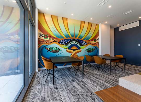 A conference room with a large mural on the wall.