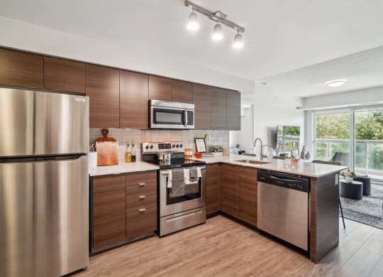 a kitchen with stainless steel appliances and wooden cabinets