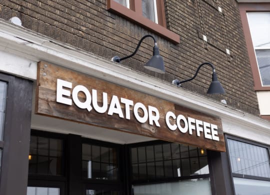 a sign on the front of a building that says equator coffee