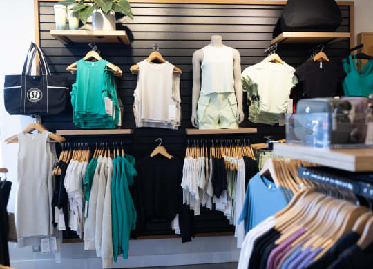 a row of clothes on hangers in a store