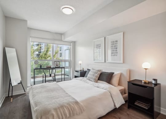 a bedroom with a large bed and a large window
