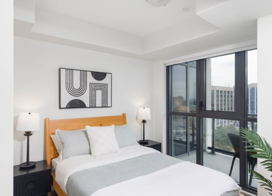 a bedroom with a bed and a large window