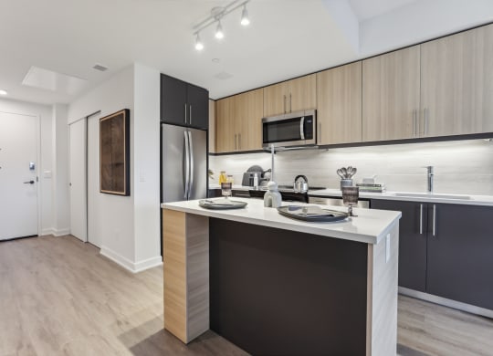 a kitchen with an island and stainless steel appliances
