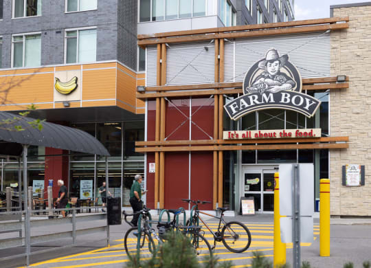 a city street scene with a farm boy restaurant in the foreground and other buildings in the background