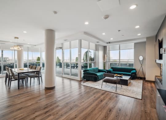 a living room with a green couch and a dining room table