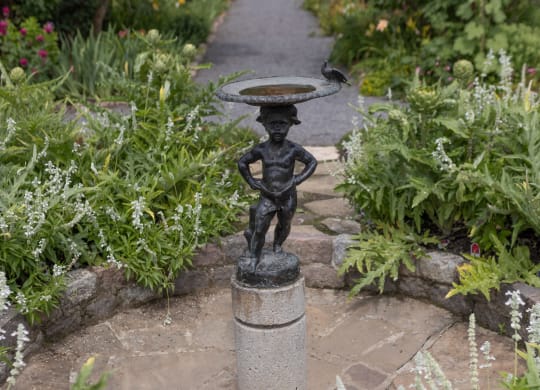 a small fountain in the middle of a garden