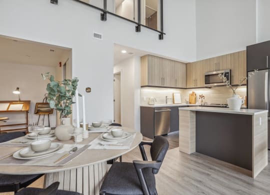 an open kitchen and dining room with a table and chairs