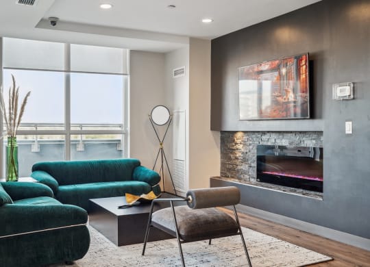a living room with green couches and a fireplace