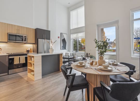 an open kitchen and dining room with a table and chairs