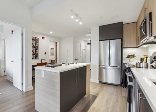 a kitchen with a large island and stainless steel appliances