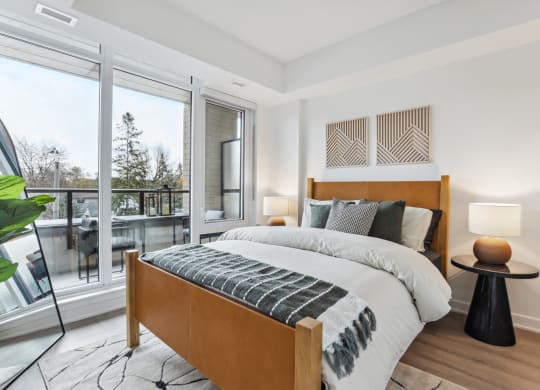 a bedroom with a bed and a large window