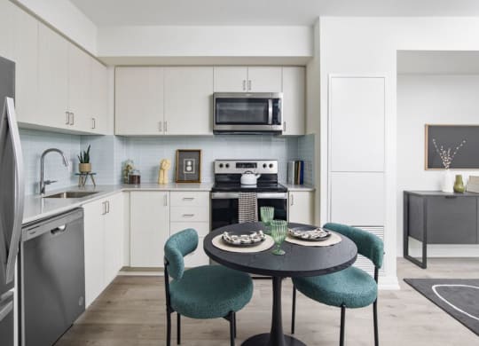 a kitchen and dining room with a table and chairs