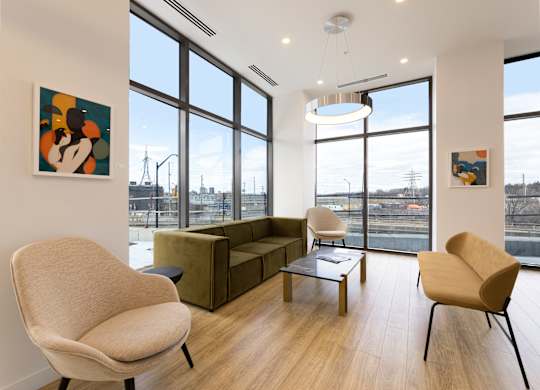 A room with a large window and a view of the city.
