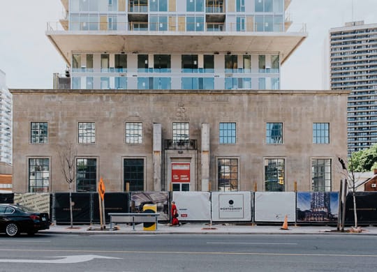 a building on the side of a street with a car