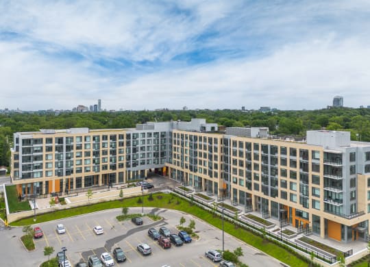 an aerial view of a large building with cars parked in front of it