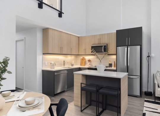 a kitchen with an island and a refrigerator