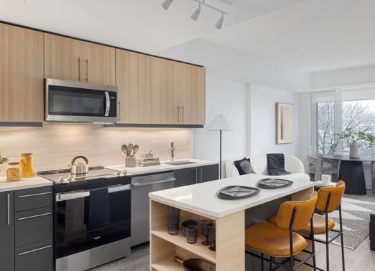 a kitchen and dining room with a table and chairs