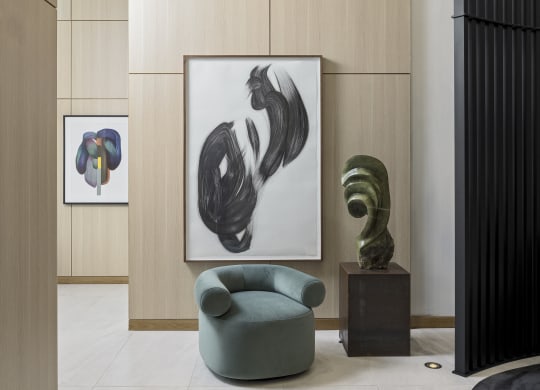 a room with a chair and a painting on the wall