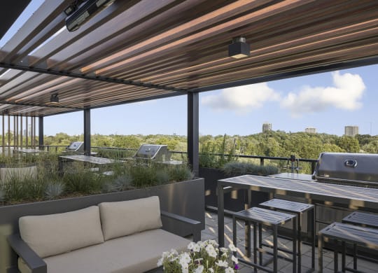 a patio with a table with chairs and a grill