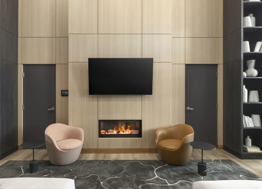 a living room with two chairs and a fireplace
