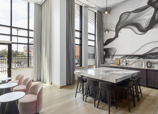 a kitchen with a marble table and chairs and a balcony
