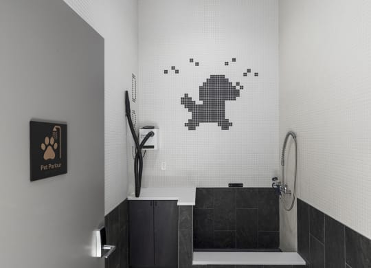 a bathroom with a white tiled wall with a pixelated frog on the wall