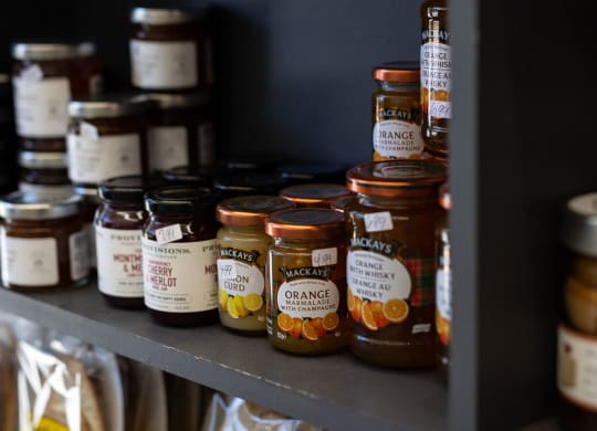 shelf with various types of jam