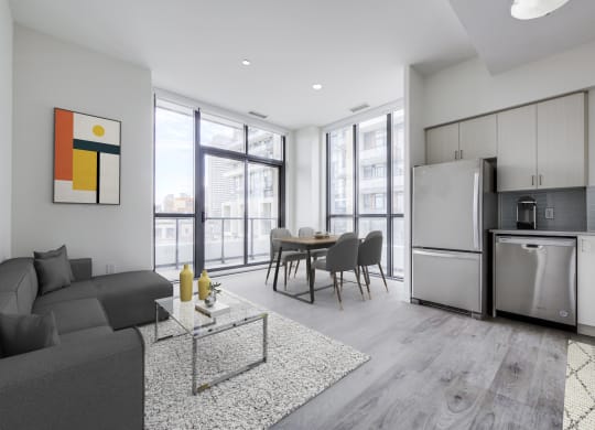 a living room with a couch and a table and a refrigerator