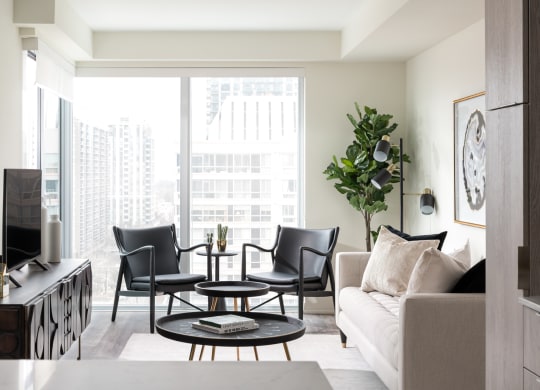 a living room with a couch and chairs and a television