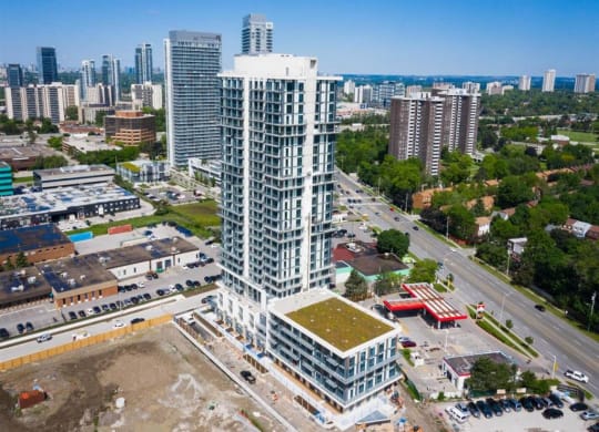 an aerial view of a skyscraper with a city in the background