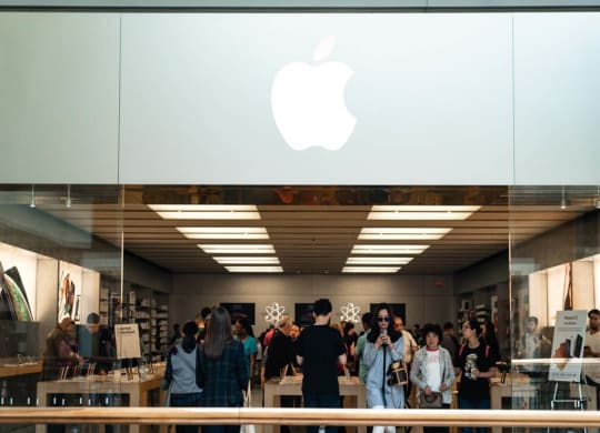 people standing in front of an apple store
