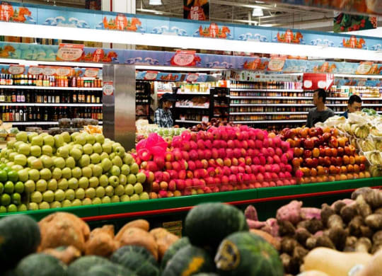 a supermarket with a display of fruits and vegetables